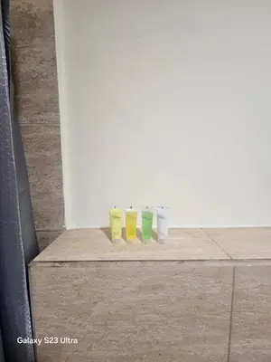 a row of four cups sitting on top of a dresser at E13 Samarah Resort Apartment in Sowayma