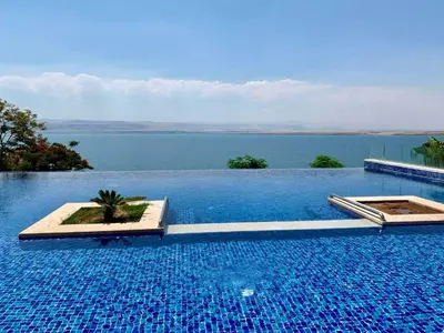 a swimming pool with a view of the water at E03 Samarah Resort Apartments in Sowayma