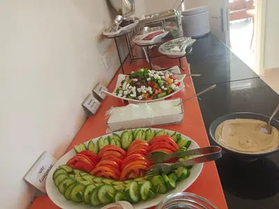 a plate of tomatoes and cucumbers on a counter at Moab Land Hotel in Madaba