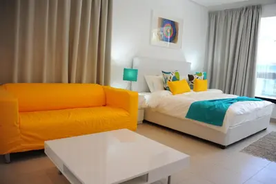 a living room with a bed and a couch at Prime Hotel in Amman