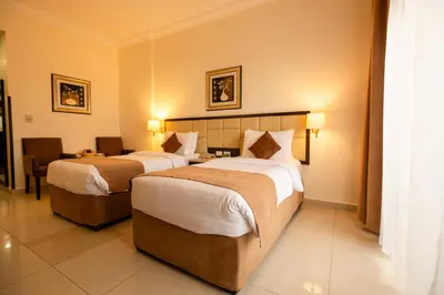 a hotel room with two beds in a room at East hotel in Sowayma