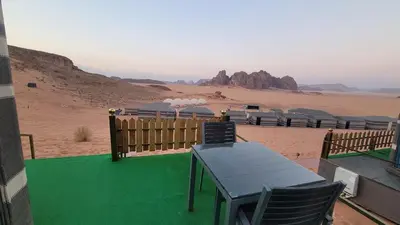 a table and chairs in the middle of the desert at Rum Gonesh Luxury Camp in Wadi Rum