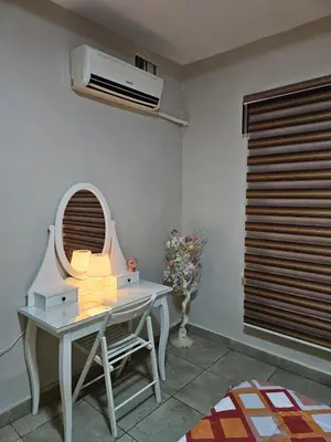 a room with a table with a mirror and a fan at 2 bedrooms apartment no 18 in Amman