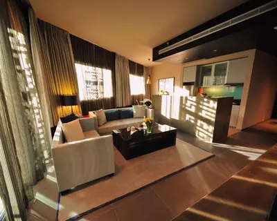 a living room with a couch and a table at The Abdali Boulevard Hotel in Amman