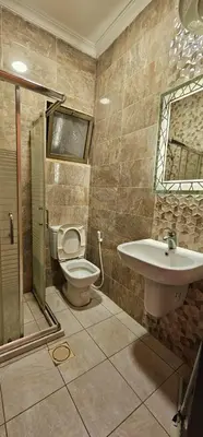 a bathroom with a toilet and a sink at MOTAMEZ APARTMENTS in Amman