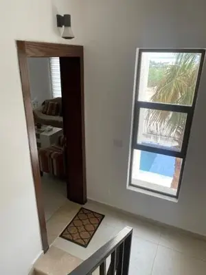 a hallway with a staircase and a window in a house at Deadsea Elite First floor shared swimming pool in Sowayma