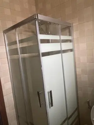 a shower with a glass door in a bathroom at Deadsea Elite First floor shared swimming pool in Sowayma