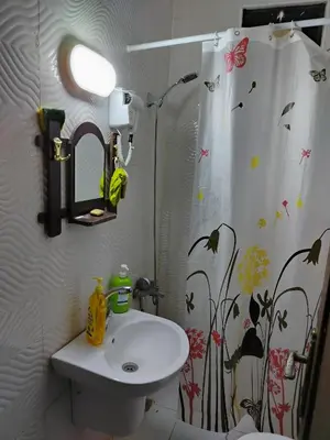 a bathroom with a sink and a shower curtain at الشقة العائلية الحديثة familial new flat in Amman
