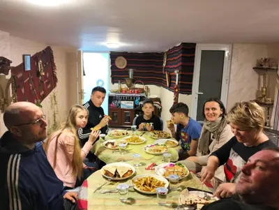 a group of people sitting around a table eating at The guset house in Kerak