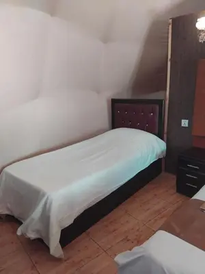 a small bedroom with a bed and a dresser at Quite bubble tent in Wadi Rum