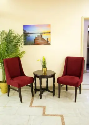 two chairs and a table in a room at Seraj Amman Hotel in Amman
