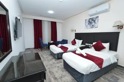 a hotel room with two beds and a television at Seraj Amman Hotel in Amman