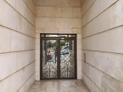 a door in a building with a stone wall at Maria Apartment in Amman