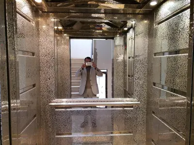 a man taking a picture of himself in a mirror at Maria Apartment in Amman