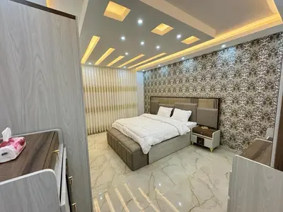 a bedroom with a bed and a wall at شقق فندقية فاخرة in Amman