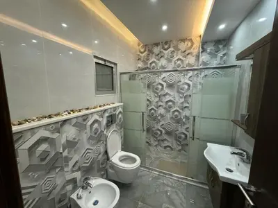 a bathroom with a toilet and a sink and a shower at شقق فندقية فاخرة in Amman