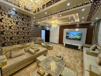 a large living room with couches and a flat screen tv at شقق فندقية فاخرة in Amman