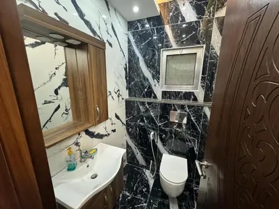 a bathroom with a sink and a toilet and a mirror at شقق فندقية فاخرة in Amman