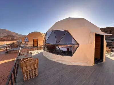 a large tent on a deck in the desert at Magical desert camp in Disah