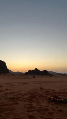 an object in the desert with the sunset in the background at Abdul Rahman Wadi Rum in Wadi Rum