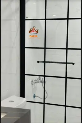 a bathroom with a shower with a toilet and a sink at Abdul Rahman Wadi Rum in Wadi Rum