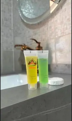 two bottles ofodorizers sitting on a counter in a bathroom at Abdul Rahman Wadi Rum in Wadi Rum