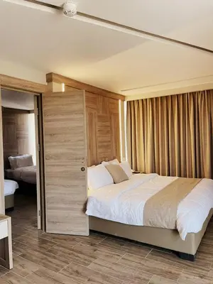 a bedroom with a large bed and a sliding door at Alena Boutique Hotel in Aqaba