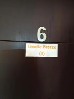 a sign on a door with the number gentle breeze at Gentle Breeze Studio 3 in Amman