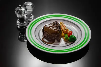 a plate of food with meat and vegetables on a table at Oryx Hotel Aqaba in Aqaba