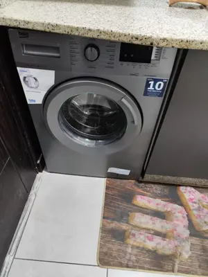 a washing machine in a kitchen with a counter at Gentle Breeze Studio 2 in Amman