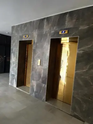 a lobby with two elevators in a building at Gentle Breeze Studio 2 in Amman
