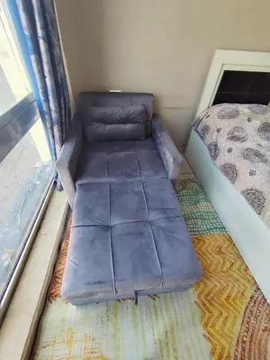 a couch in a room with a bed and a window at Gentle Breeze Studio 2 in Amman