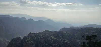 a view of a mountain range with clouds in the sky at Dana local life Eco Lodge in Dana