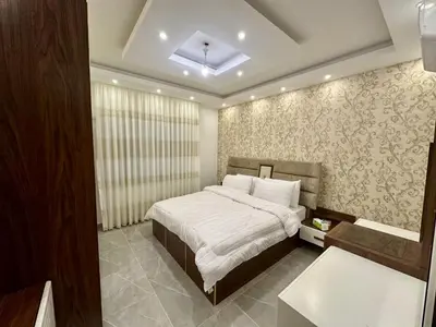 a bedroom with a bed with white sheets and a window at شقق فندقية فاخرة عمّان in Amman