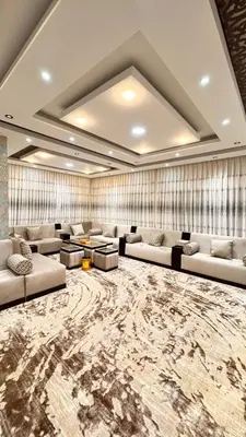 a living room with couches and a large rug at شقق فندقية فاخرة عمّان in Amman