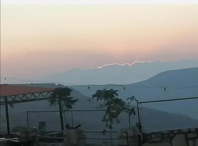 a view of a mountain with trees in the foreground at Al-Karak Countryside and hotel in Ad Dimnah