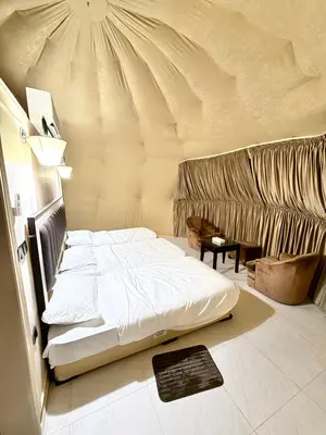 a bedroom with a large bed in a tent at Glow of Wadi Rum Camp in Wadi Rum