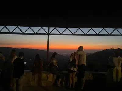 a group of people standing on top of a mountain at sunset at Heritige Inn Jordan in Ad Dimnah