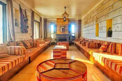 a large living room with couches and a fireplace at Heritige Inn Jordan in Ad Dimnah