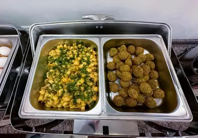 a tray of food in an oven with a tray of food at Petra Premium Hotel in Wadi Musa
