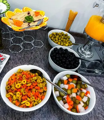 a table with bowls of vegetables and other foods at Petra Premium Hotel in Wadi Musa