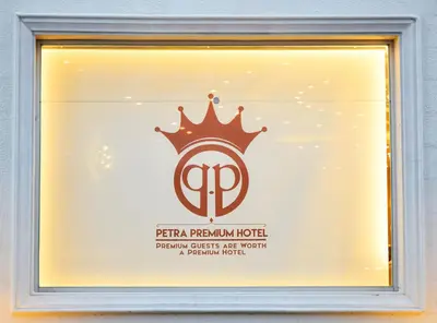 a sign in a window with a crown on it at Petra Premium Hotel in Wadi Musa