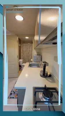 a kitchen with a sink and a stove top oven at gardens st 2 beds apartment 411 in Amman
