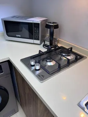 a microwave sitting on a counter next to a stove at new furnished studio gardens st 329 in Amman