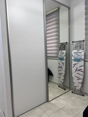 a mirror in front of a bathroom with a toilet at new furnished studio gardens st 329 in Amman