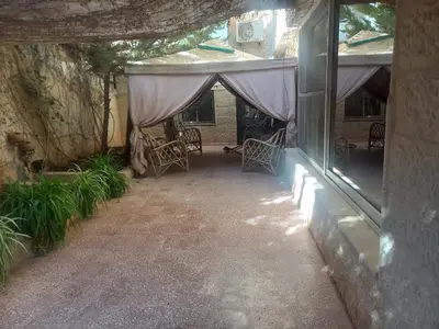 an outdoor patio with a tent with chairs and plants at شقه مفروشه مع حديقه اربد بجانب فندق فلامنجو ومدارس دار العلوم in Irbid