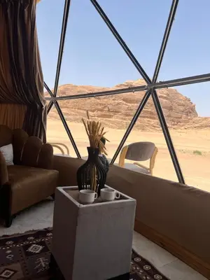 a living room with a view of the desert at Desert Boulevard Camp in Wadi Rum