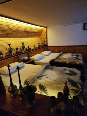 a bedroom with two beds and a table with a table sidx sidx at Mickey Mouse studio in Jerash