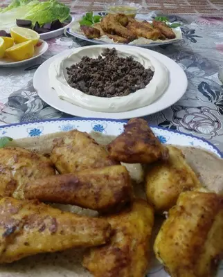 three plates of food on a table with plates of food at Mickey Mouse studio in Jerash