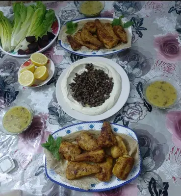 a table with three plates of food on it at Mickey Mouse studio in Jerash